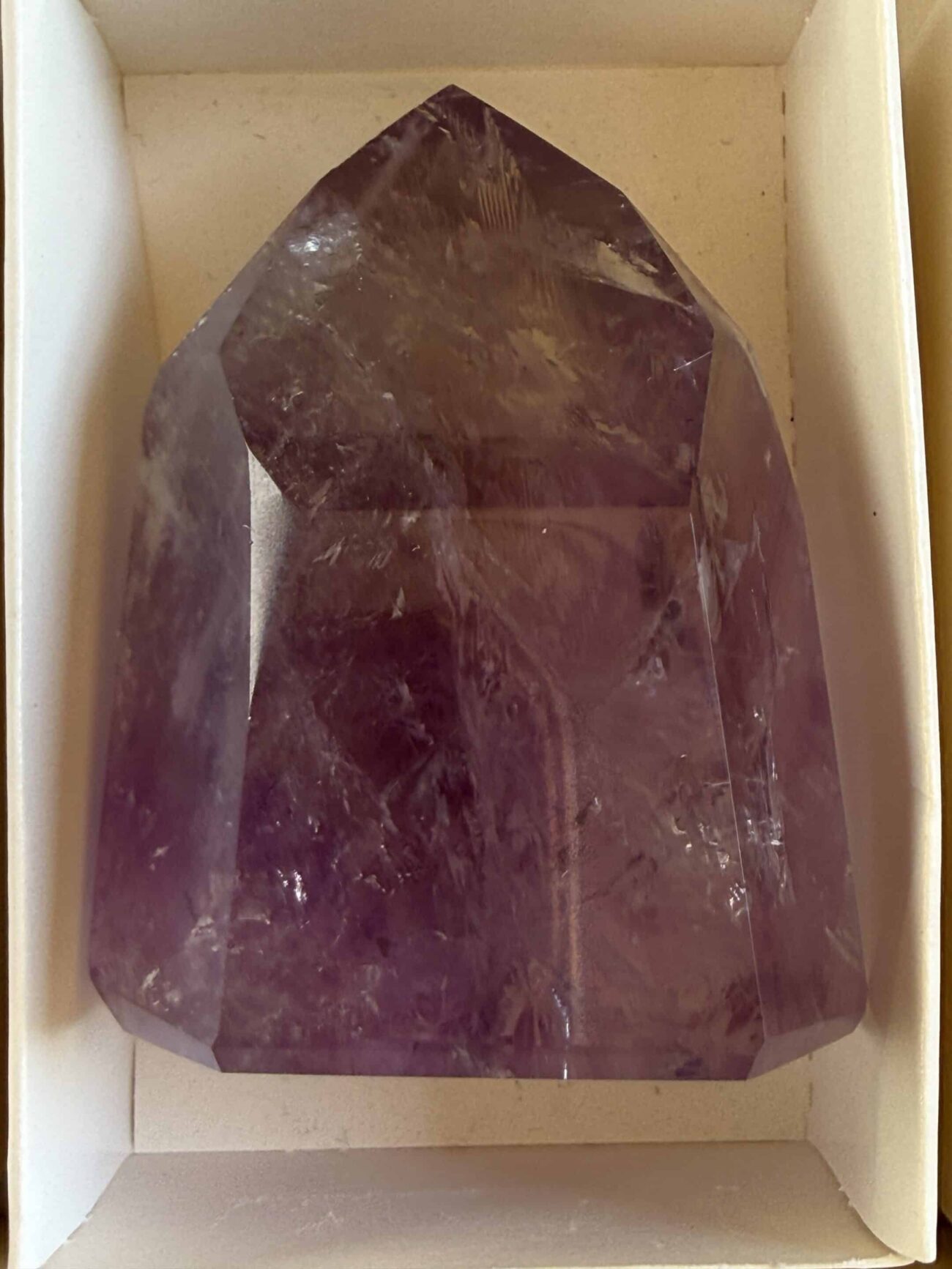 This Brazilian Old Stock Feathered Dow Crystal showcases the kind of internal beauty that collectors rarely forget. Delicate feathering, luminous veils, remarkable transparency, and a sought-after Trans Channeling formation create a crystal with extraordinary depth and character. Light reveals layer after layer of suspended formations throughout the specimen, making every viewing angle a new experience.