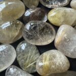 Golden Rutilated Quartz Tumbled Stones with visible golden rutile inclusions